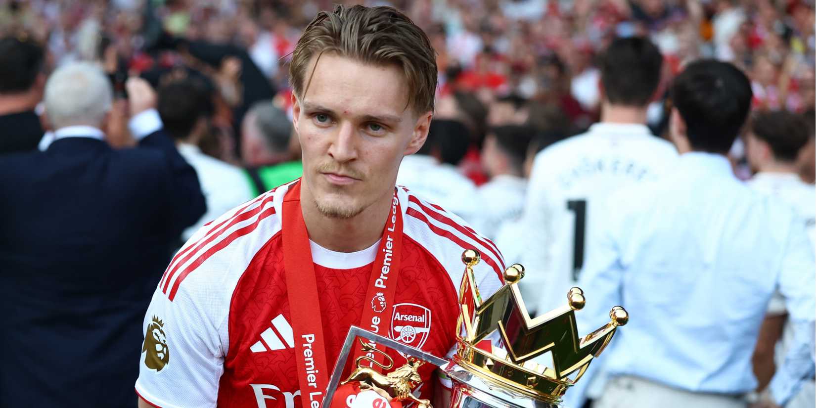 Arsenal's Martin Odegaard celebrates with the trophy after winning the Premier League