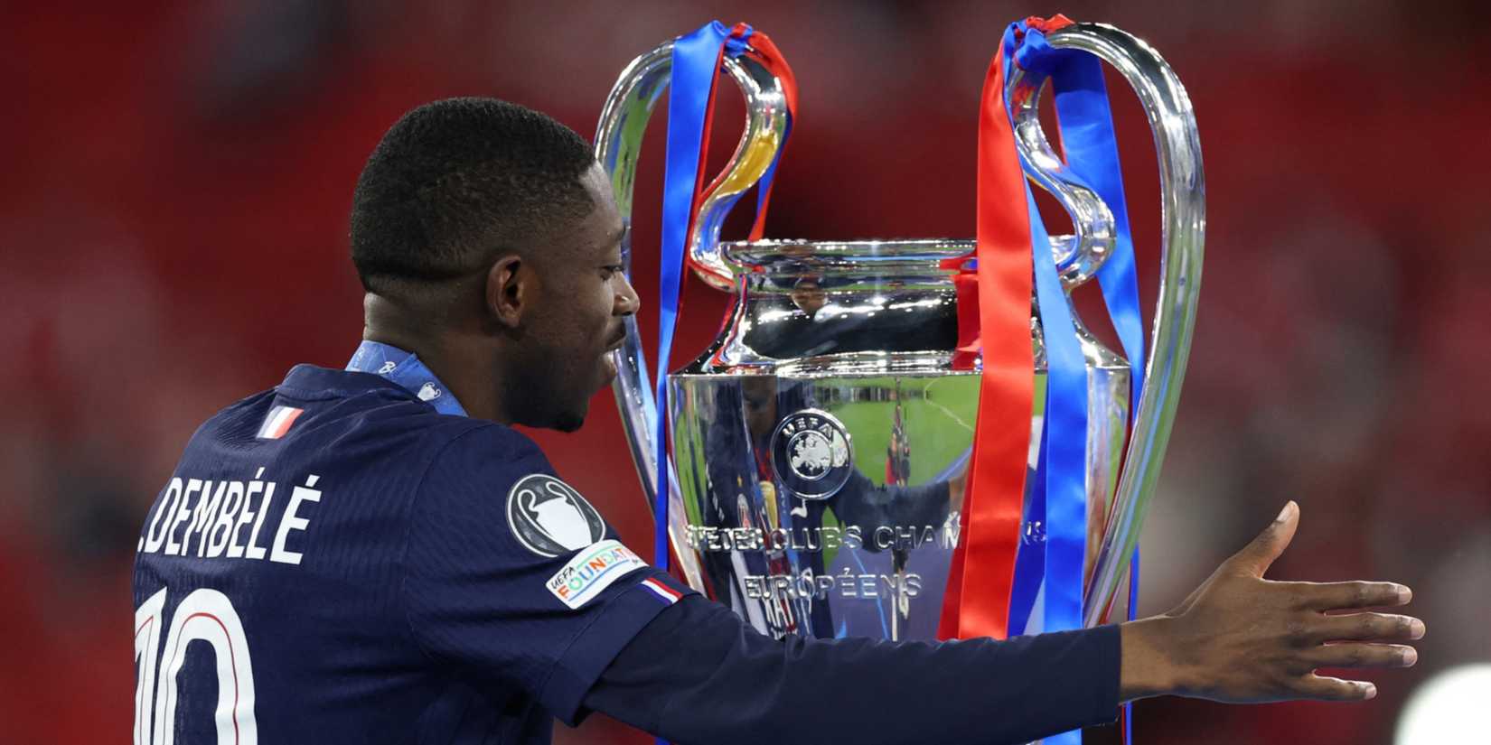 Paris St Germain's Ousmane Dembele celebrates with the trophy after winning the UEFA Champions League