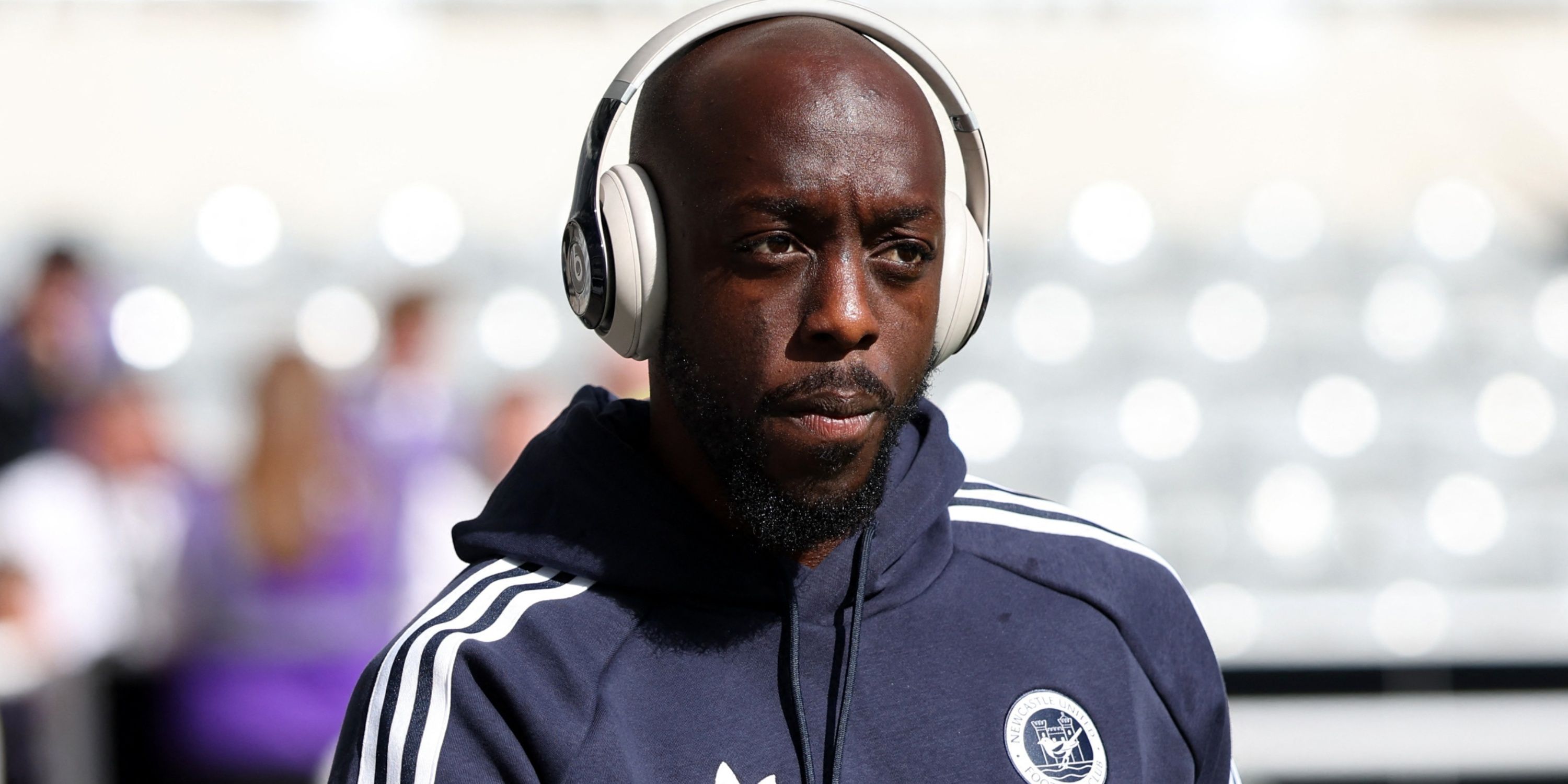 Newcastle attacker Yoane Wissa wears headphones on way into stadium