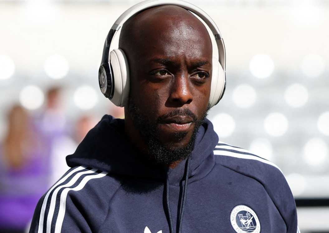 Newcastle attacker Yoane Wissa wears headphones on way into stadium