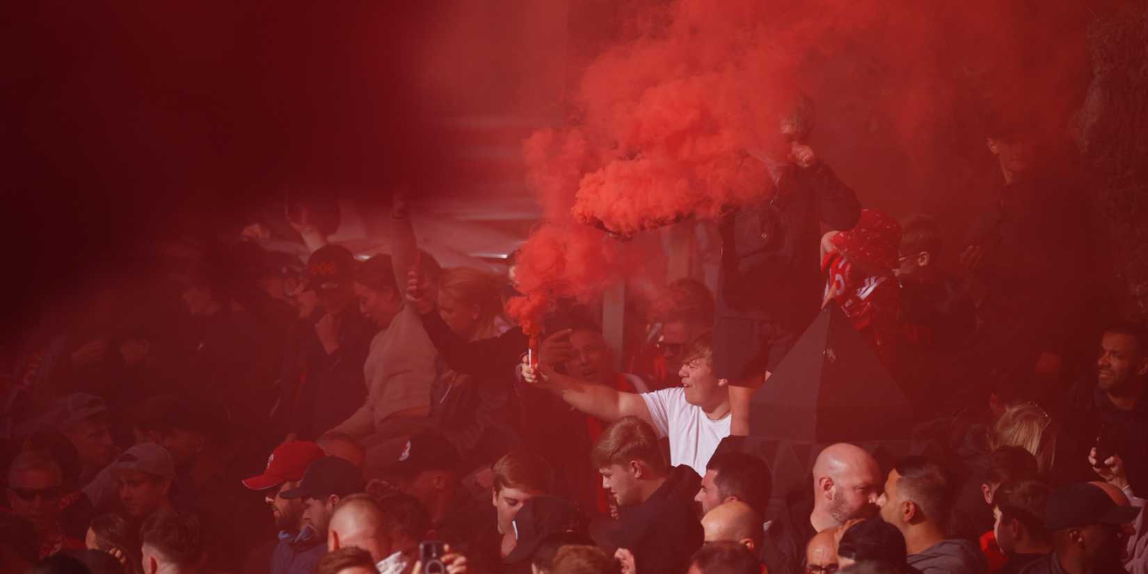 Liverpool fans with flares outside Anfield