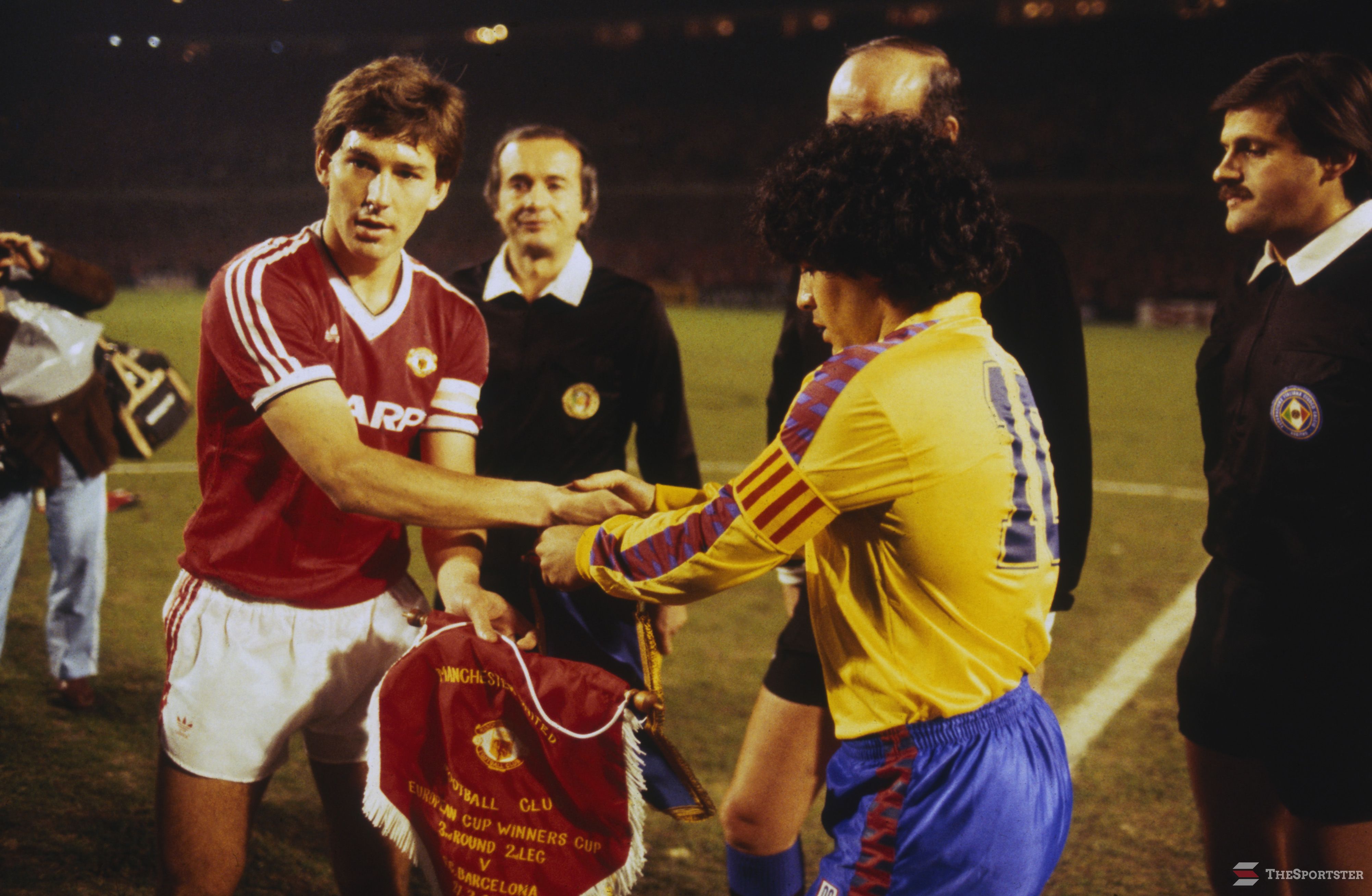 MANCHESTER - MARCH 21: Captain Bryan Robson (left) of Manchester United shakes hands with Barcelona captain Diego Maradona before the European Cup Winners Cup Quarter-Final Second Leg match between Manchester United and Barcelona held on March 21, 1984 at Old Trafford, in Manchester, England. Manchester United won the match 3-0, winning the tie 3-2 on aggregate. (Photo by Trevor Jones/Getty Images)
